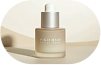 Lumière serum bottle in warm light